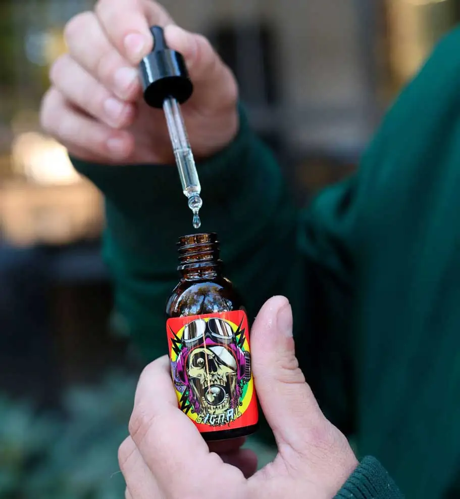 Signal Scissor Hands moisturizing beard oil in a dropper bottle for beard care and hydration.