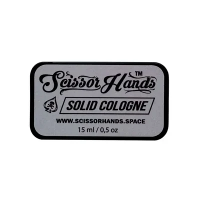 Grey solid cologne by Scissor Hands in a metal case with a woody-resinous fragrance.