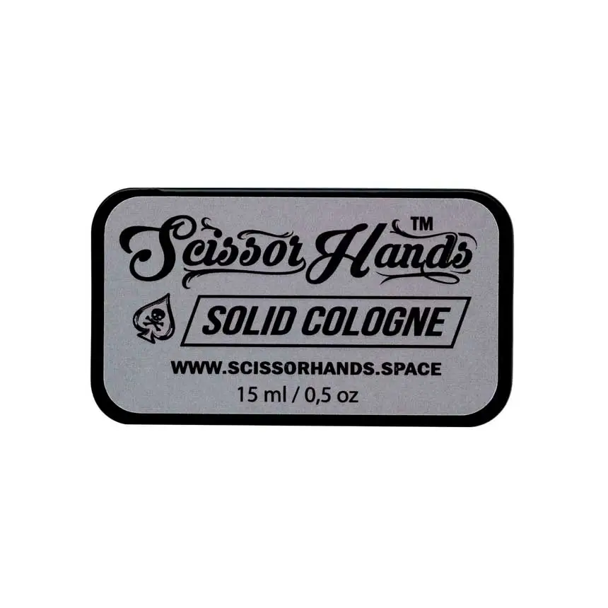 Grey solid cologne by Scissor Hands in a metal case with a woody-resinous fragrance.