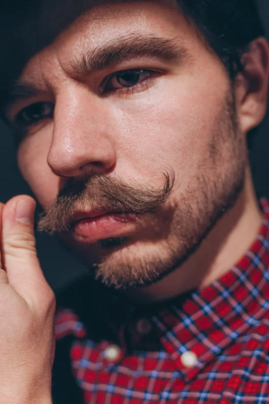 Handlebar moustache — men's curled mustache styled with mustache wax.