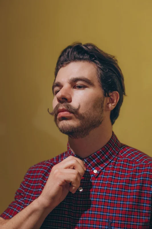 Men's curled mustache — a classic moustache style styled with mustache wax.
