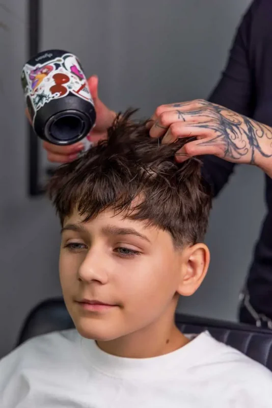 Blow-drying children’s hair before applying Scissor Hands Liquid Wax to increase volume