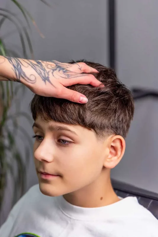 Shaping a hairstyle by hand after applying Scissor Hands Liquid Wax to create volume and direction